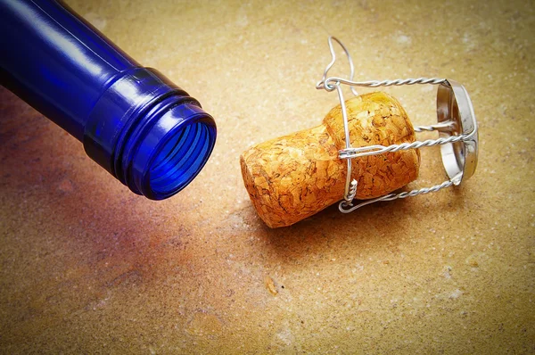 Blue bottle with closeup of a champagne cork — Stock Photo, Image