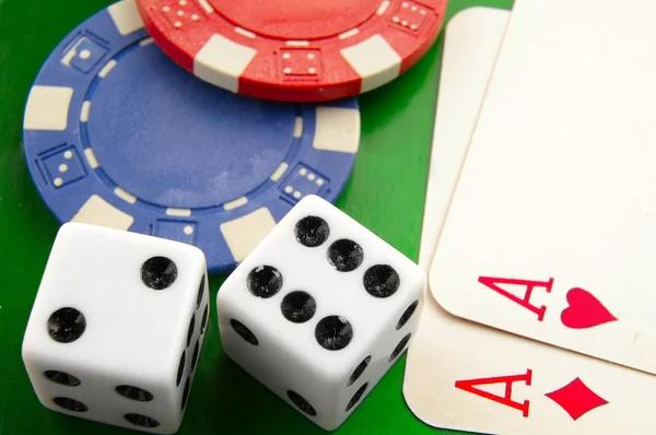 Stacked poker chips and dice on white — Stock Photo, Image