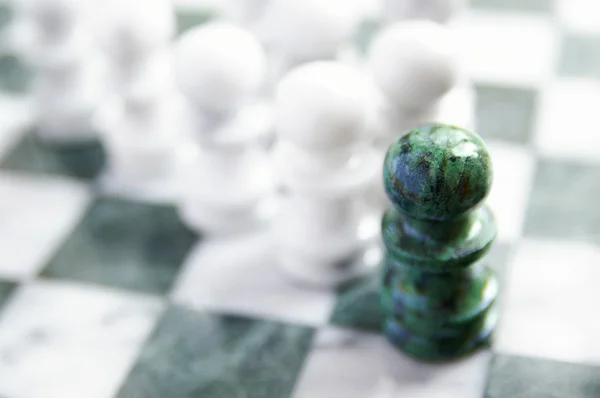 Group of chess pawns, one ahead of the others — Stock Photo, Image