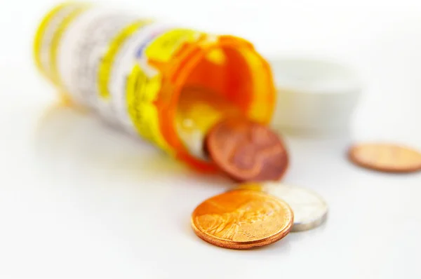 Pill bottle with coins — Stock Photo, Image