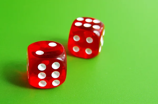 Two red dice closeup on green table — Stock Photo, Image