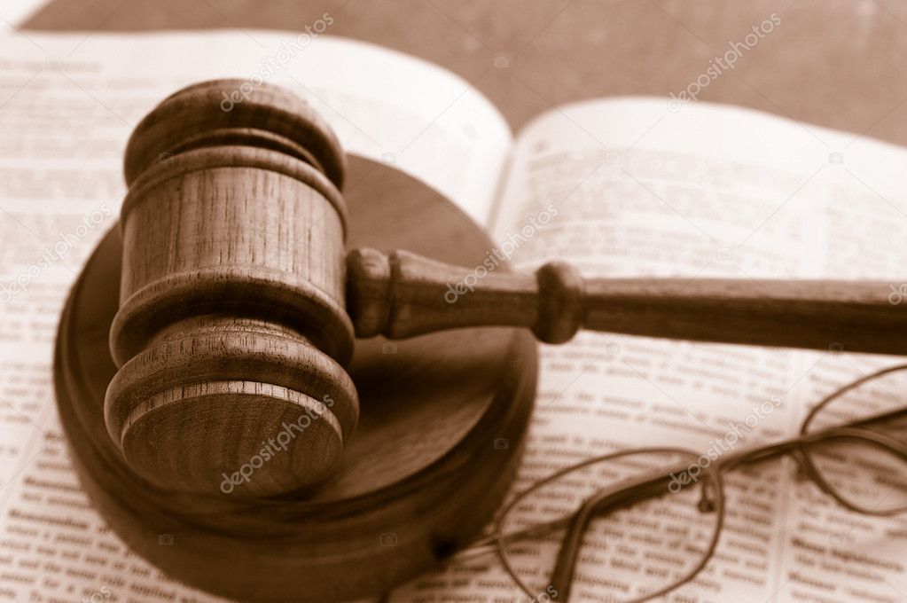 Judges court gavel on a law book with glasses