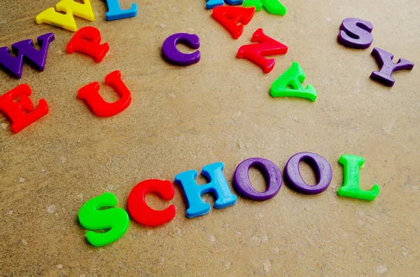 Children's colorful plastic letters spelling out "school" — Stock Photo, Image