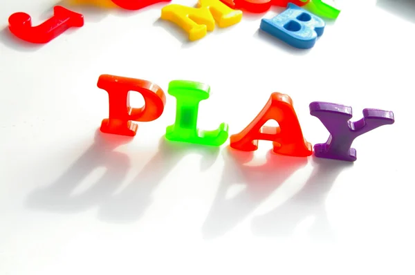 Children's colorful plastic letters spelling "work" — Stock Photo, Image