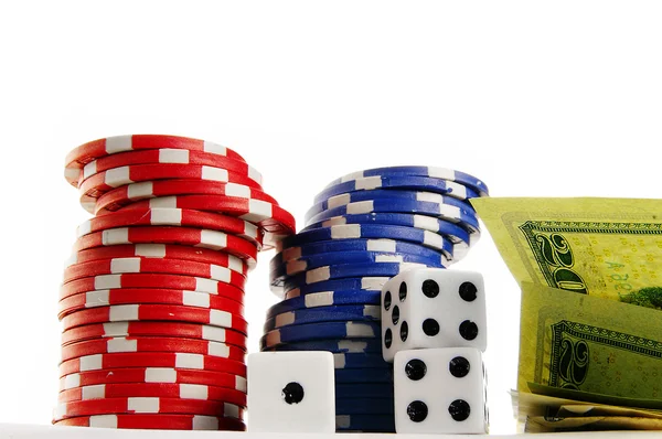 Stacked poker chips cash and dice on white — Stock Photo, Image