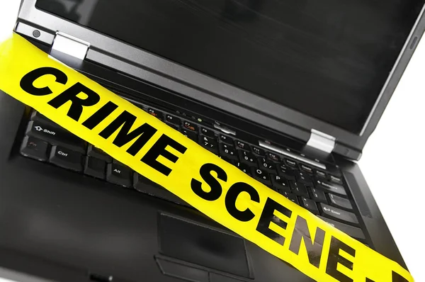 Laptop com fita de cena de crime — Fotografia de Stock