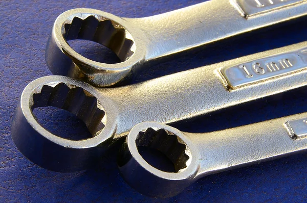 Wrenches closeup on textured blue surface — Stock Photo, Image