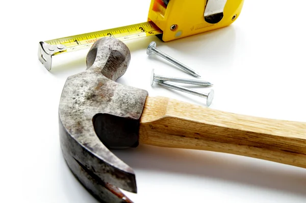 Hammer, nails and tape-measure on white — Stock Photo, Image
