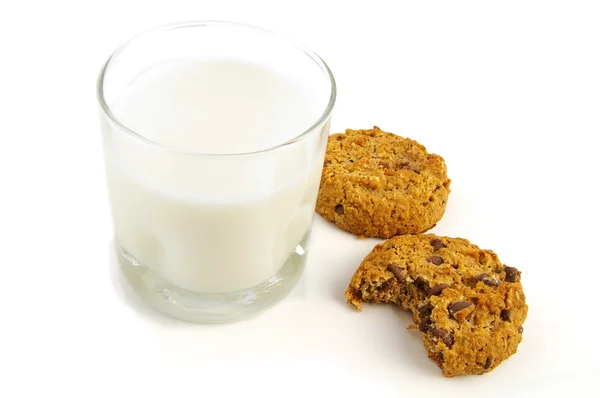 stock image Chocolate chip cookies and glass of milk on white