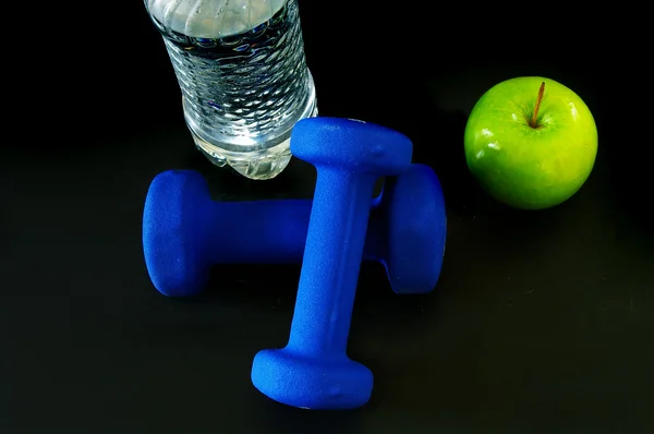 Bootle of water, weight and green apple — Stock Photo, Image