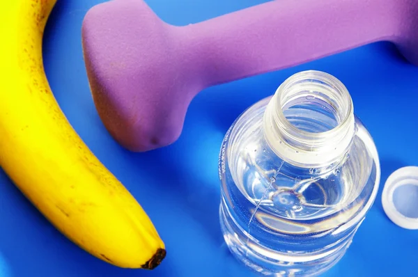 Bottle of water, banana, and small weight — Stock Photo, Image