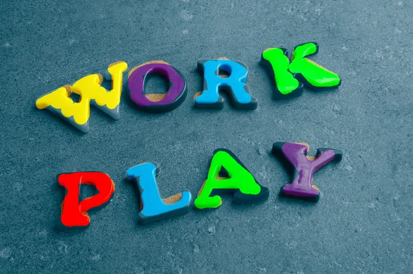 Children's colorful plastic letters spelling out "work" — Stock Photo, Image