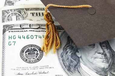 Graduation cap on money clipart