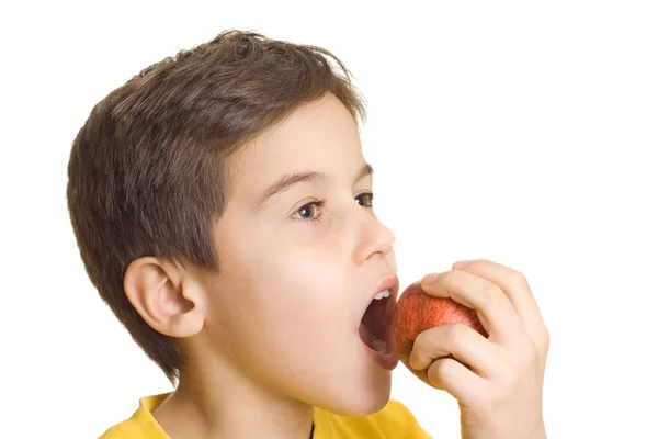 Niño comiendo manzana Imagen de archivo