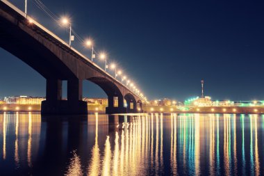 Night city lights reflected from surface of river clipart