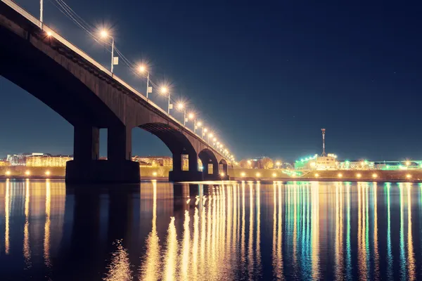 Night city lights reflected from surface of river — Stock Photo, Image