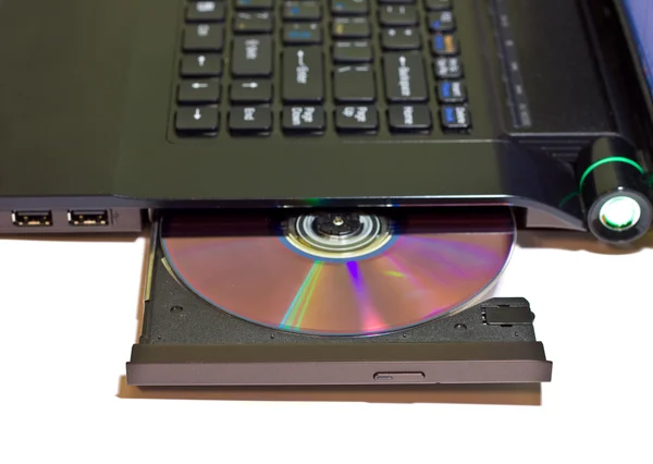 Laptop com um DVD em disco — Fotografia de Stock