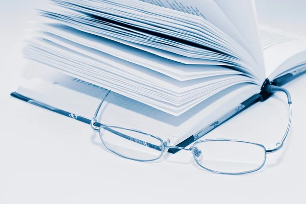 Closeup of opened books and glasses — Stock Photo, Image