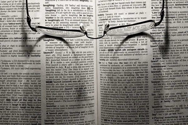 Glasses on the dictionary — Stock Photo, Image