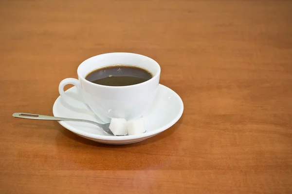 Table with a cup of coffe — Stock Photo, Image