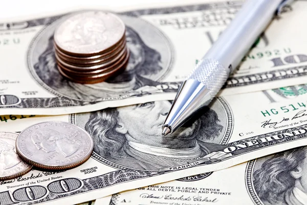 Coins, dollars and pen — Stock Photo, Image