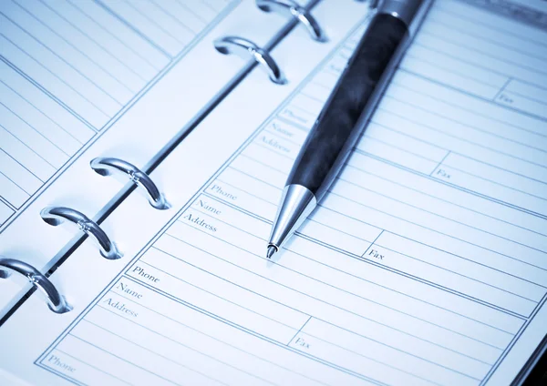 stock image Pen lying on opened notebook