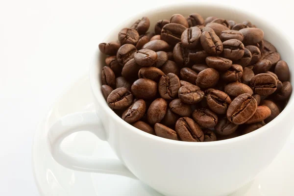 Cup with coffee beans — Stock Photo, Image