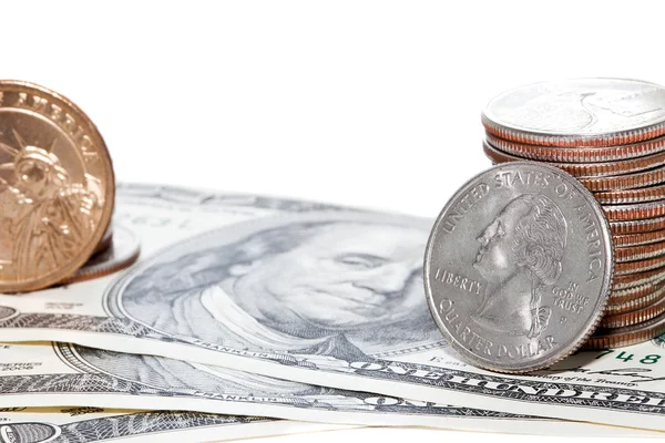 Stapels munten over dollar achtergrond — Stockfoto