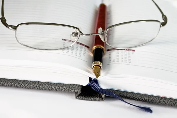 Długopis, okulary i porządek obrad — Zdjęcie stockowe