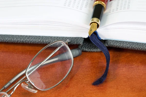 Planejador diário com óculos e caneta — Fotografia de Stock
