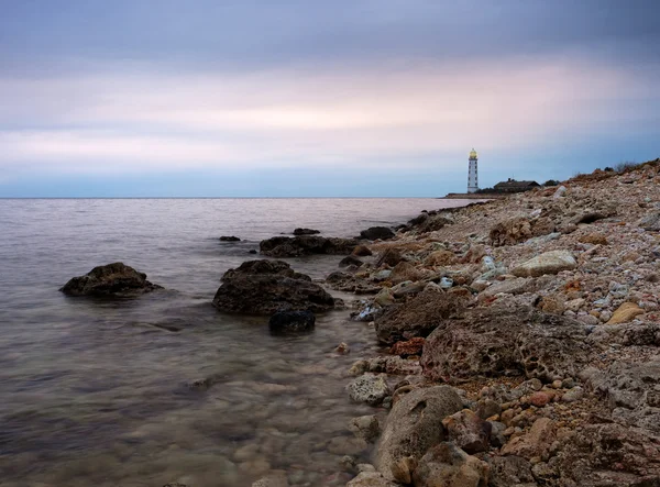 Lighthouse at rocky shore — Stock Photo, Image