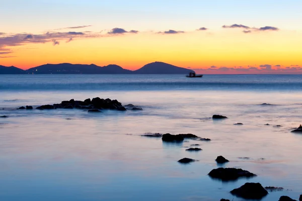 stock image Sunrise on rocky sea coast