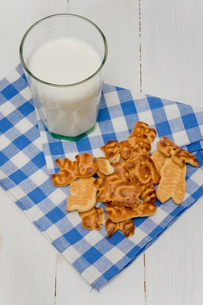 Milk and cookies on checkered napkin — Stock Photo, Image
