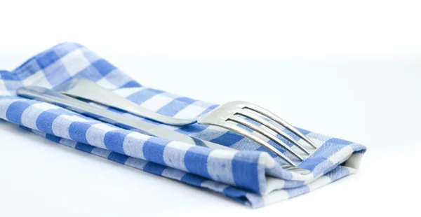 Fork and knife on a checkered napkin — Stock Photo, Image