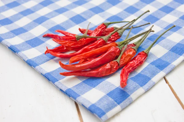 stock image Red hot peppers on plaid napkin