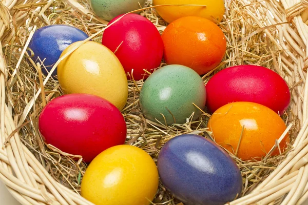 Painted easter eggs in a basket — Stock Photo, Image