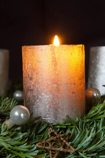 Рождественский венок с одной горящей свечой — стоковое фото