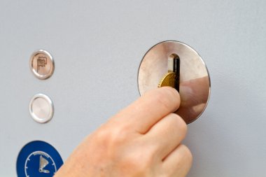 Hand inserting coin into a machine clipart