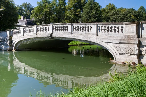 stock image Stone bridge crossing the „Nymphenburg“ canal in Munich, Germany