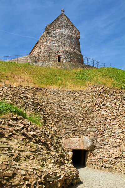 Entrance to the megalithic tomb of La Hougue Bie with Chapel, Jersey, UK