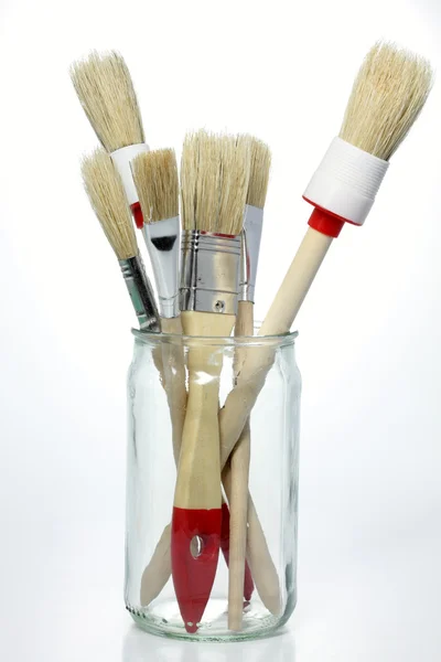 Paintbrushes in a glass, isolated — Stock Photo, Image