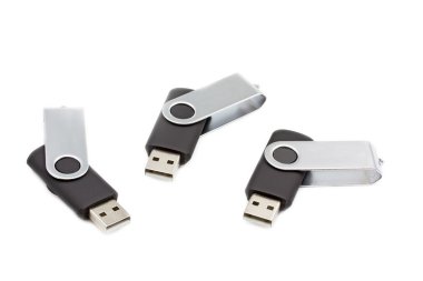 Three portable usb flash drives on white background clipart