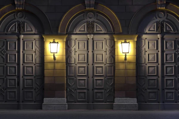 Dwie latarnie oświetlające zabytkowe drzwi — Zdjęcie stockowe