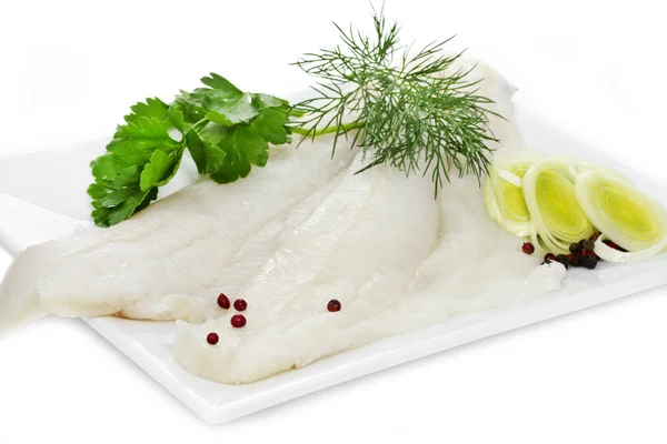 Halibut fillets on a white plate — Stock Photo, Image