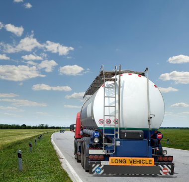 Big fuel gas tanker truck on highway clipart