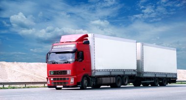 Red truck moving on a highway clipart