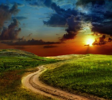 Beautiful view of the sunset in a field on a rural road clipart