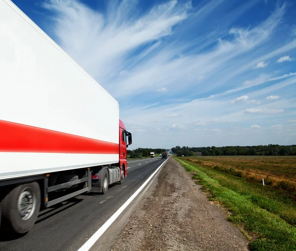 Красный грузовик движется по шоссе — стоковое фото
