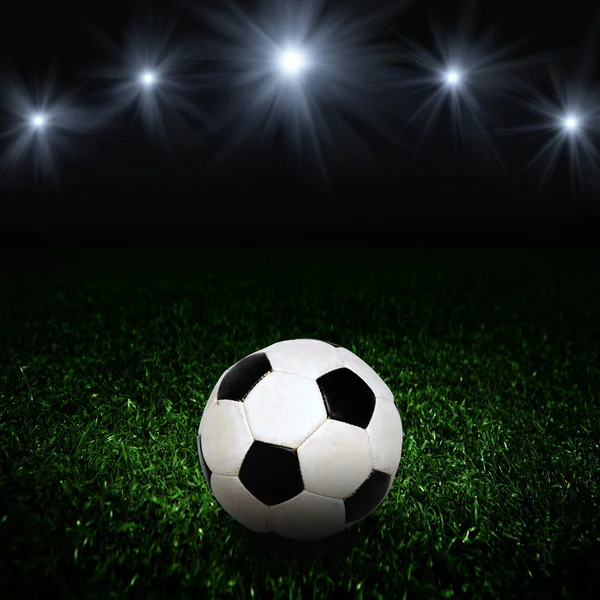 Soccer ball on the field of stadium with light — Stock Photo, Image