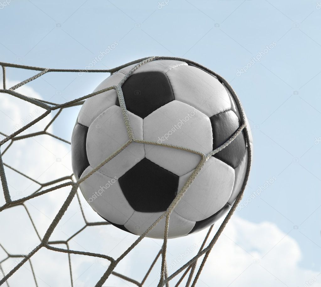 Football. The ball flies into the net gate